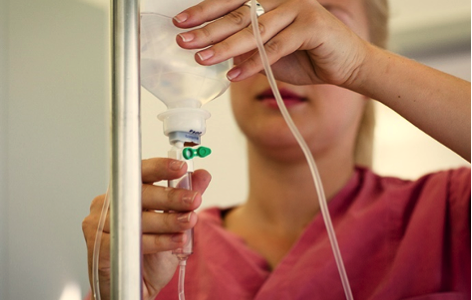 Nurse sets up IV ketamine infusion for depression treatment.