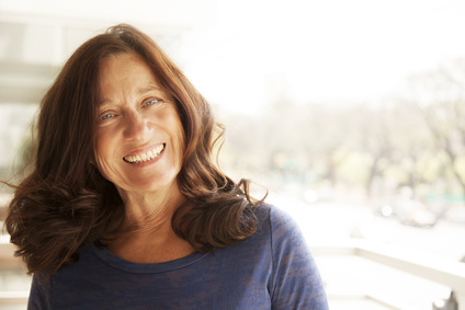 Photo of happy, mature woman who enjoys the flow in her life as she pursues her passion and is fulfilled.