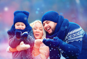 Photo of family catching snowflakes who have found happiness in their relationships