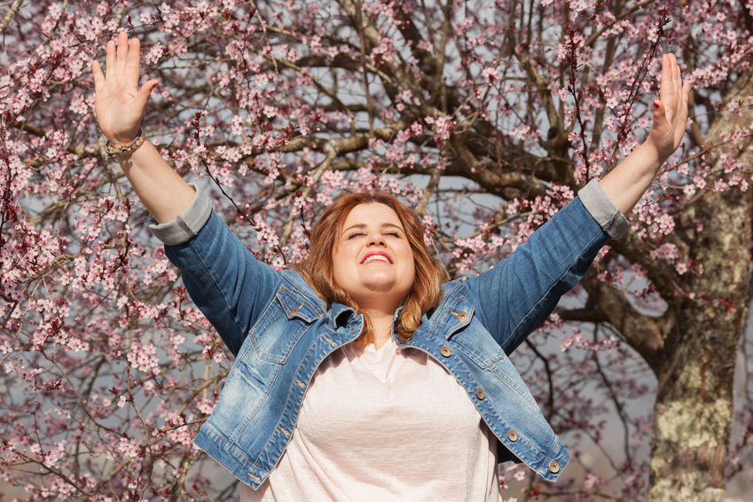 This lady raises her hands in gratefulness with an attitude of gratitude