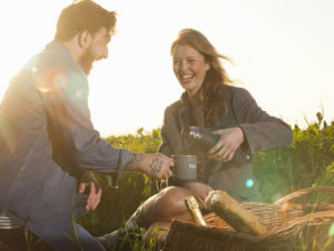 Young couple enjoys a picnic in the country after ketamine wannabe drug treatment for treatment resistant mood disorders.