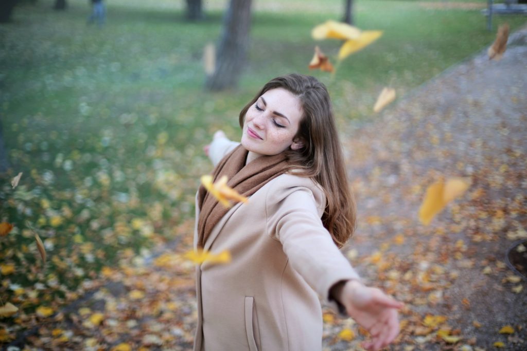 Woman twirling in relief from remission of depression.