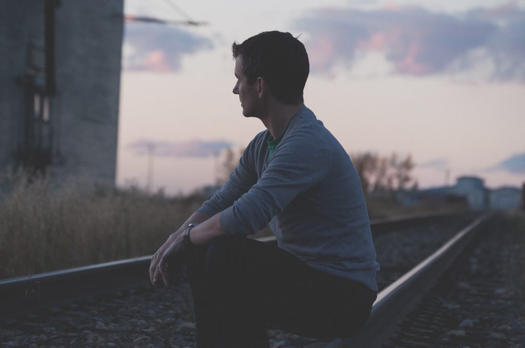 Gary sits on the railroad track with severe chronic depression.